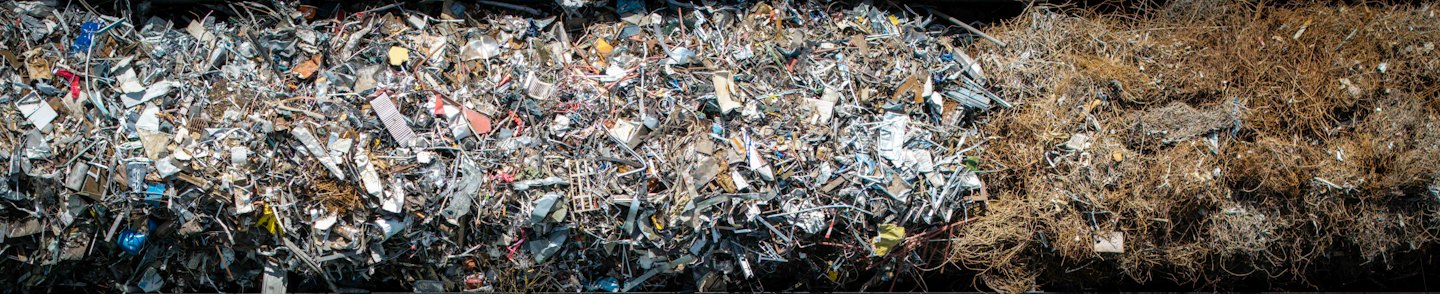 A large pile of industrial scrap metal and oxidized wires.